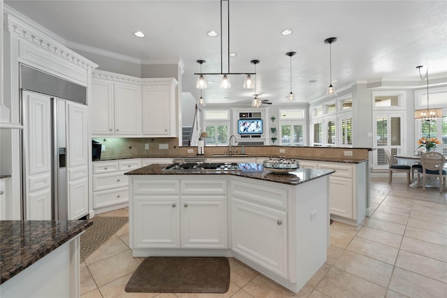 9611 Stonebridge Pl, Tomball, TX 77375 - kitchen with a sink, ornamental molding, light tile patterned flooring, decorative backsplash, and a kitchen island