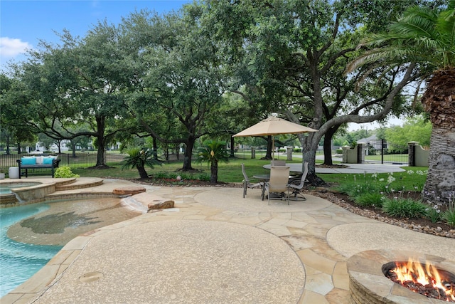 9611 Stonebridge Pl, Tomball, TX 77375 - view of patio / terrace with a fire pit and a pool with connected hot tub