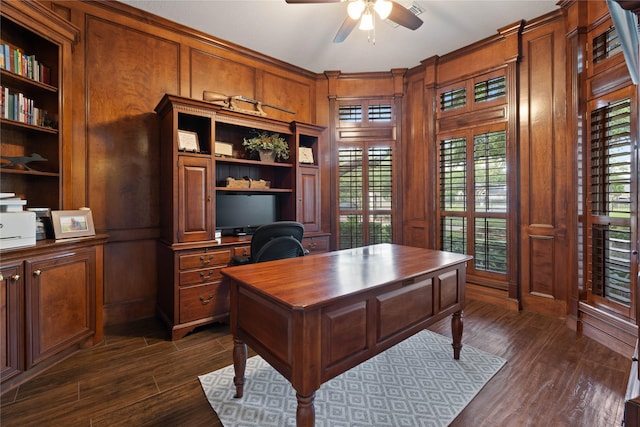 9611 Stonebridge Pl, Tomball, TX 77375 - office with ceiling fan, dark wood-style floors, built in shelves, ornamental molding, and wood walls