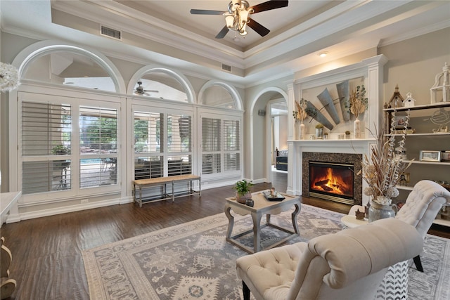 9611 Stonebridge Pl, Tomball, TX 77375 - living room featuring a ceiling fan, ornamental molding, a lit fireplace, a raised ceiling, and wood finished floors