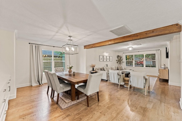 9382 Livernois Rd, Houston, TX 77080 - dining area with a textured ceiling, a chandelier, light wood-type flooring, beam ceiling, and baseboards