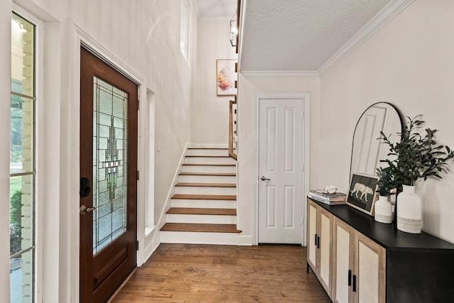 9382 Livernois Rd, Houston, TX 77080 - foyer entrance featuring crown molding, stairs, wood finished floors, and a textured ceiling