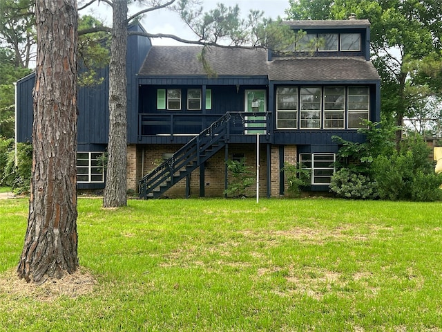 10011 Schanzer Rd, Hitchcock, TX 77563 - view of front of property with stairs, a front yard, roof with shingles, and brick siding