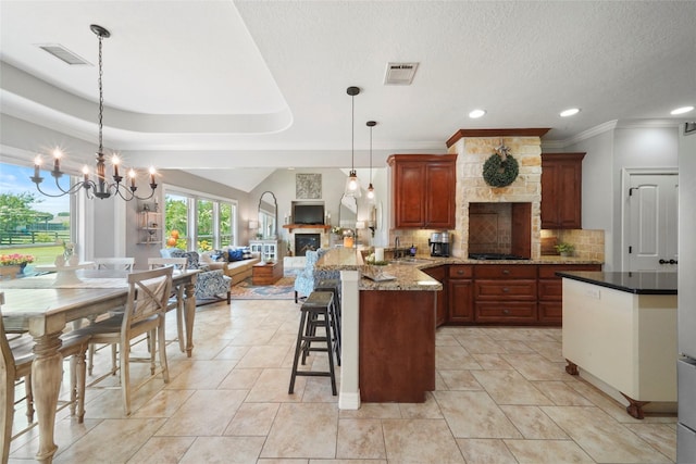 5112 E Settlers Bnd, Montgomery, TX 77316 - kitchen with a peninsula, a sink, tasteful backsplash, a fireplace, and black gas cooktop