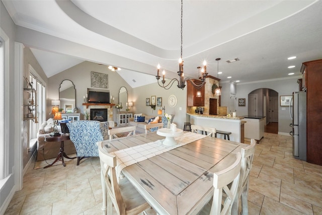 5112 E Settlers Bnd, Montgomery, TX 77316 - dining room featuring arched walkways, a glass covered fireplace, recessed lighting, a chandelier, and ornamental molding