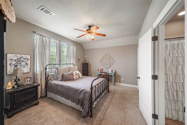 5112 E Settlers Bnd, Montgomery, TX 77316 - bedroom featuring carpet, a ceiling fan, baseboards, vaulted ceiling, and a textured ceiling