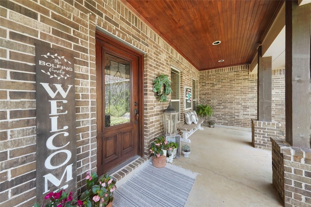 5112 E Settlers Bnd, Montgomery, TX 77316 - doorway to property featuring brick siding and covered porch