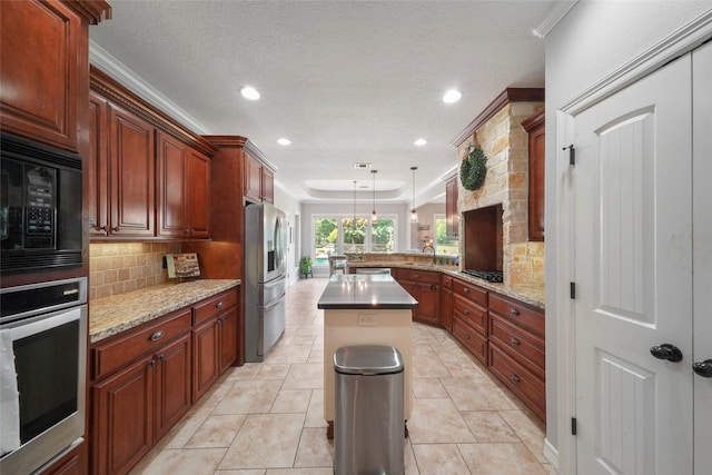 5112 E Settlers Bnd, Montgomery, TX 77316 - kitchen featuring wall oven, stainless steel fridge, black microwave, a peninsula, and decorative backsplash