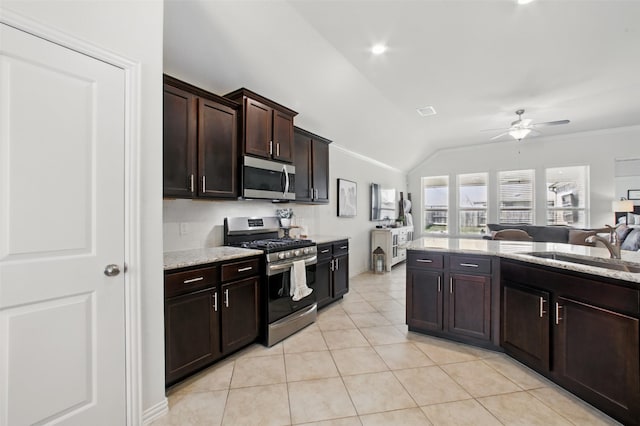4609 Autumn Morning Dr, Spring, TX 77386 - kitchen featuring appliances with stainless steel finishes, lofted ceiling, a sink, ceiling fan, and light tile patterned floors