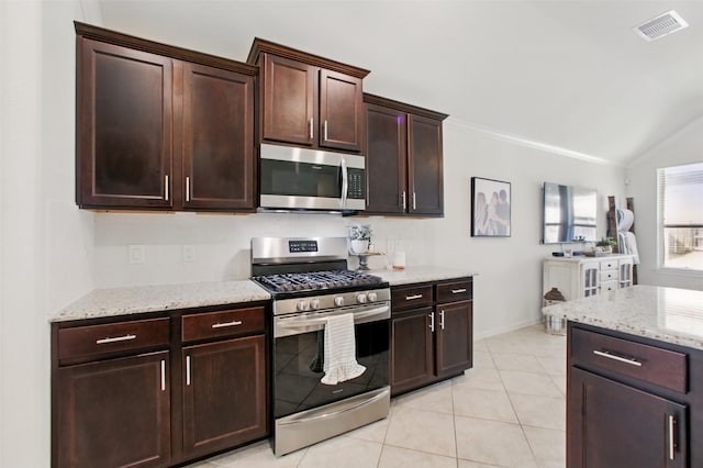 4609 Autumn Morning Dr, Spring, TX 77386 - kitchen featuring stainless steel appliances, vaulted ceiling, light stone counters, ornamental molding, and light tile patterned flooring