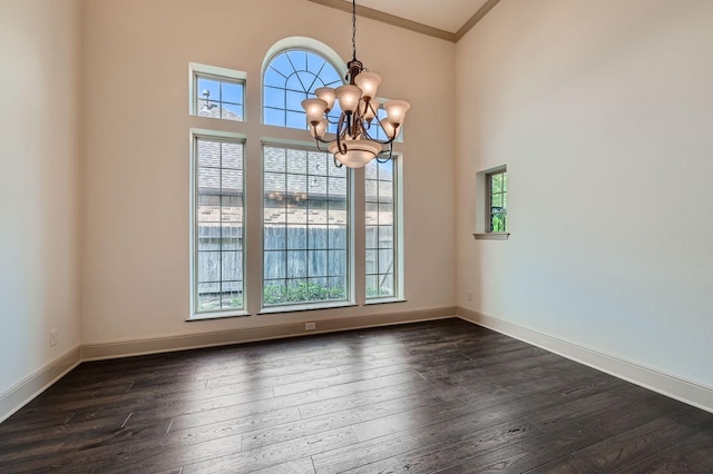 2806 King Point View Ln, Spring, TX 77388 - unfurnished dining area featuring a chandelier, dark wood-type flooring, crown molding, baseboards, and a high ceiling