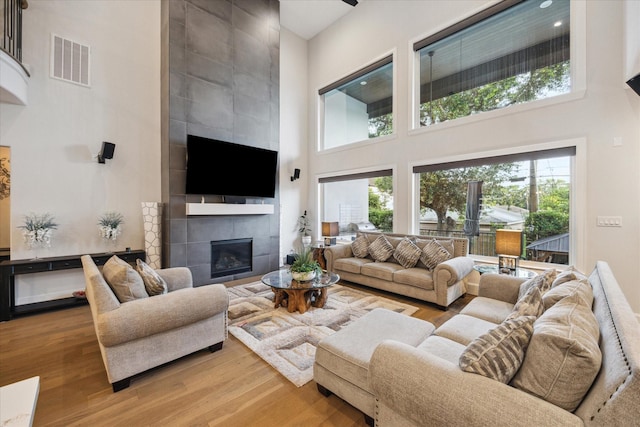 4019 Drummond St, Houston, TX 77025 - living room featuring a towering ceiling, wood finished floors, and a fireplace