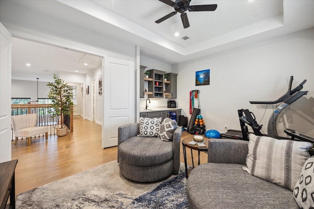 4019 Drummond St, Houston, TX 77025 - living room featuring light wood-style floors, a ceiling fan, recessed lighting, attic access, and a raised ceiling