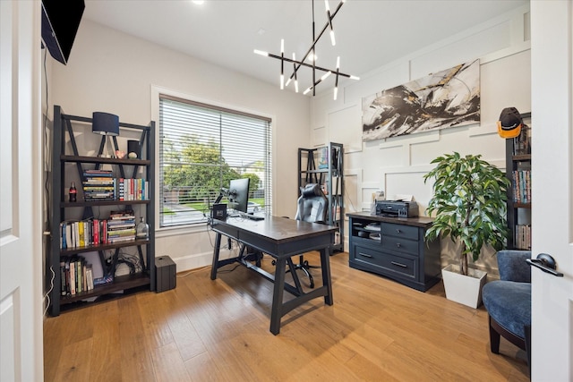 4019 Drummond St, Houston, TX 77025 - office space with light wood-type flooring, a chandelier, and baseboards