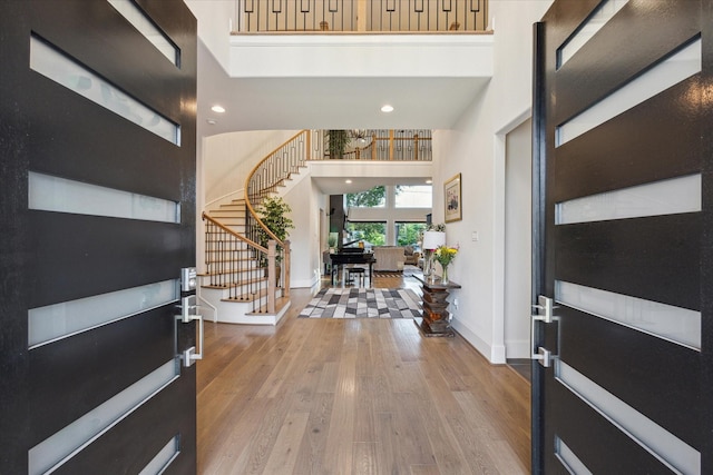 4019 Drummond St, Houston, TX 77025 - entryway featuring stairway, baseboards, wood finished floors, a towering ceiling, and recessed lighting