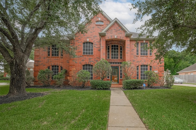 11943 Natural Bridges Ln, Sugar Land, TX 77498 - view of front facade with brick siding and a front yard
