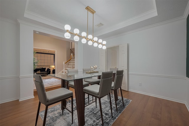 11943 Natural Bridges Ln, Sugar Land, TX 77498 - dining area featuring stairway, a tray ceiling, wood finished floors, baseboards, and crown molding