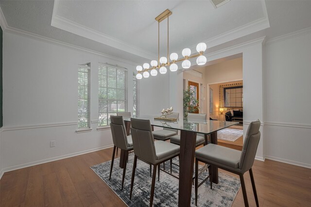 11943 Natural Bridges Ln, Sugar Land, TX 77498 - dining space with healthy amount of natural light, wood finished floors, baseboards, and crown molding