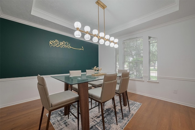 11943 Natural Bridges Ln, Sugar Land, TX 77498 - dining room featuring wood finished floors, a tray ceiling, ornamental molding, and baseboards