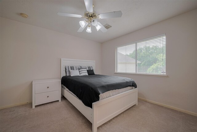 11943 Natural Bridges Ln, Sugar Land, TX 77498 - bedroom with light colored carpet, baseboards, and ceiling fan