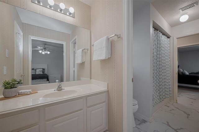 11943 Natural Bridges Ln, Sugar Land, TX 77498 - bathroom featuring connected bathroom, marble finish floors, toilet, and vanity