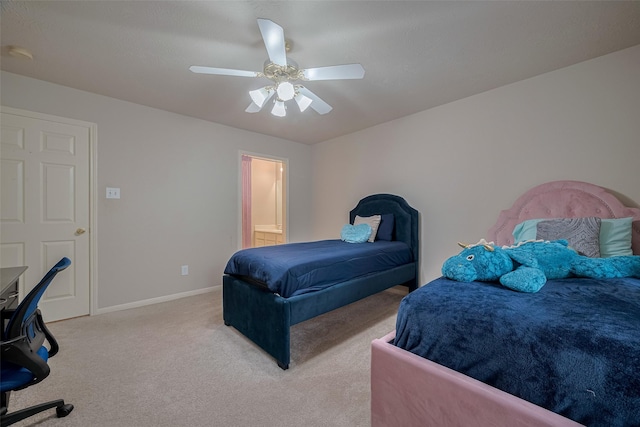 11943 Natural Bridges Ln, Sugar Land, TX 77498 - bedroom with light colored carpet, baseboards, an office area, a ceiling fan, and ensuite bath