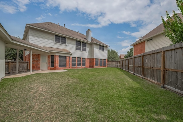 11943 Natural Bridges Ln, Sugar Land, TX 77498 - back of property featuring brick siding, a chimney, a patio, and roof with shingles
