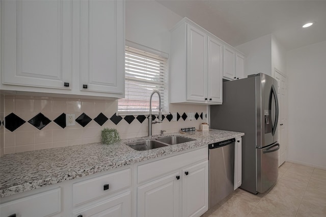 11943 Natural Bridges Ln, Sugar Land, TX 77498 - kitchen with a sink, stainless steel appliances, white cabinets, decorative backsplash, and recessed lighting