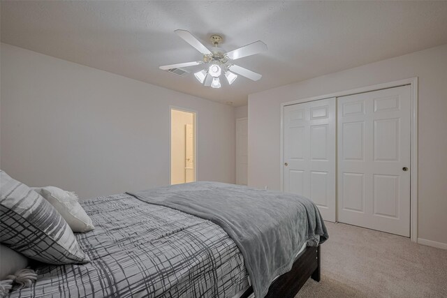 11943 Natural Bridges Ln, Sugar Land, TX 77498 - bedroom with light colored carpet, a closet, a ceiling fan, and baseboards