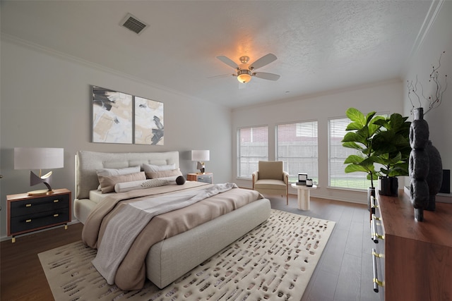 11943 Natural Bridges Ln, Sugar Land, TX 77498 - bedroom featuring crown molding, wood finished floors, a ceiling fan, and a textured ceiling