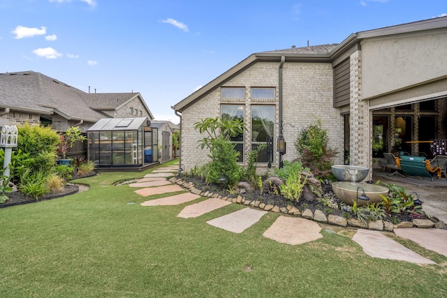 2715 Merlin Way, Katy, TX 77493 - view of yard with a greenhouse, an outdoor structure, and a patio area