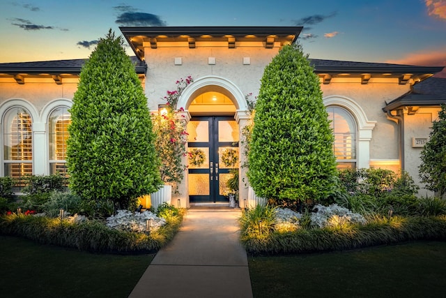 2715 Merlin Way, Katy, TX 77493 - exterior entry at dusk featuring stucco siding and french doors