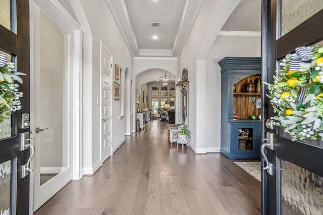 2715 Merlin Way, Katy, TX 77493 - foyer entrance with arched walkways, dark wood-type flooring, baseboards, a chandelier, and ornamental molding