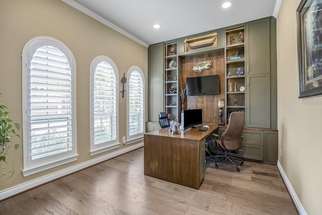 2715 Merlin Way, Katy, TX 77493 - office with light wood finished floors, crown molding, baseboards, built in shelves, and recessed lighting