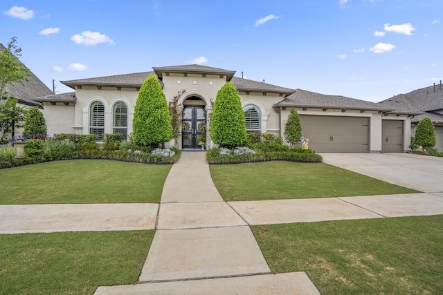 2715 Merlin Way, Katy, TX 77493 - mediterranean / spanish-style home with stucco siding, an attached garage, french doors, and a front yard