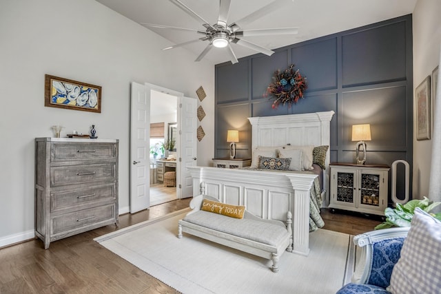 2715 Merlin Way, Katy, TX 77493 - bedroom with wood finished floors, ensuite bath, baseboards, a high ceiling, and ceiling fan