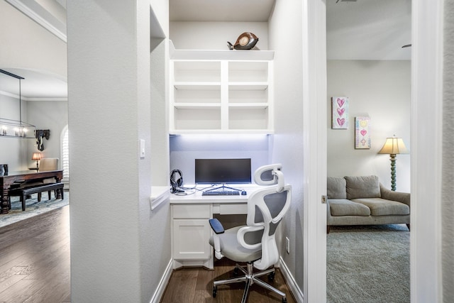 2715 Merlin Way, Katy, TX 77493 - office featuring dark wood-style flooring, baseboards, arched walkways, built in study area, and a chandelier
