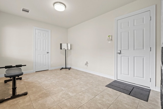 10822 Brittmoore Oaks Pl, Houston, TX 77043 - workout area featuring light tile patterned flooring and baseboards