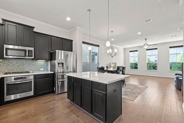 10822 Brittmoore Oaks Pl, Houston, TX 77043 - kitchen featuring stainless steel appliances, dark cabinetry, a kitchen island, backsplash, and ceiling fan