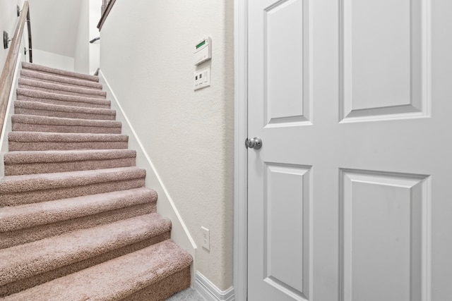 10822 Brittmoore Oaks Pl, Houston, TX 77043 - staircase with baseboards and a textured wall