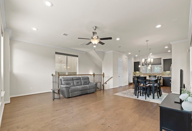 10822 Brittmoore Oaks Pl, Houston, TX 77043 - living area with crown molding, ceiling fan, recessed lighting, baseboards, and a chandelier