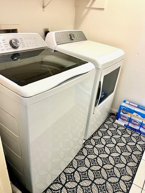 6610 Grand Haven Dr, Houston, TX 77088 - washroom with independent washer and dryer and tile patterned floors