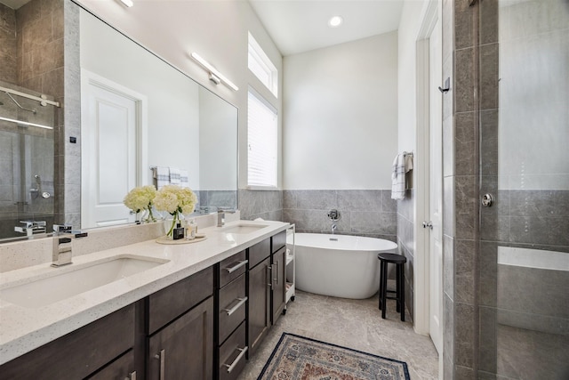 809 Burton Landing Ln, Houston, TX 77008 - full bathroom with a shower stall, double vanity, a freestanding bath, tile walls, and wainscoting
