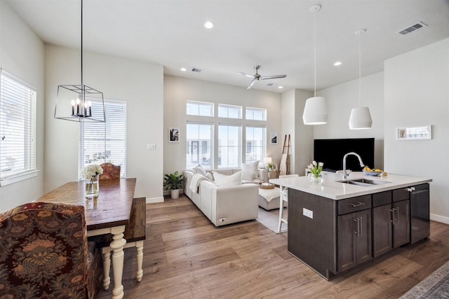 809 Burton Landing Ln, Houston, TX 77008 - kitchen featuring open floor plan, a sink, dark brown cabinets, light wood-type flooring, and recessed lighting