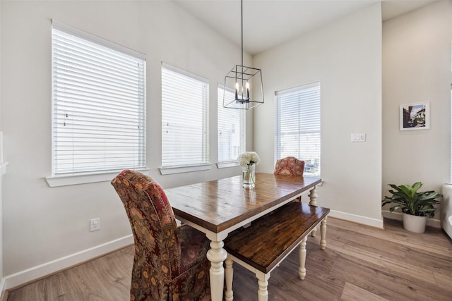 809 Burton Landing Ln, Houston, TX 77008 - dining space with baseboards, a chandelier, and light wood-style floors