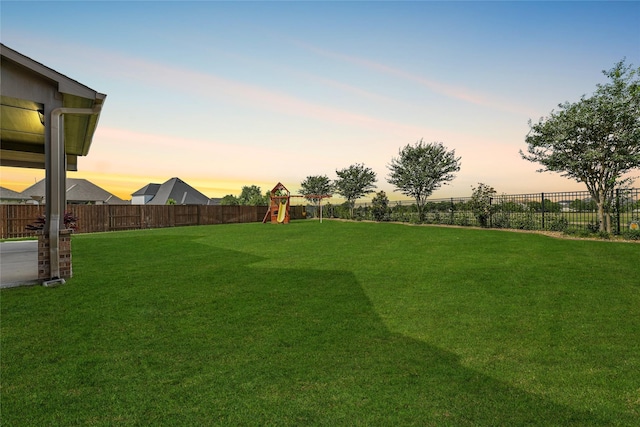 2603 Open Prairie Ln, Katy, TX 77493 - yard at dusk featuring a playground and a fenced backyard