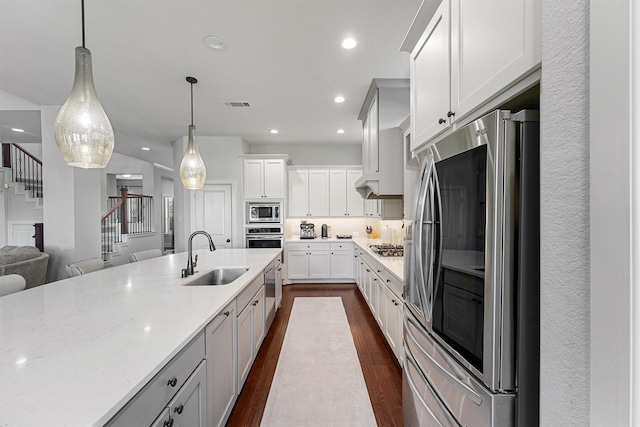 2603 Open Prairie Ln, Katy, TX 77493 - kitchen featuring stainless steel appliances, a sink, dark wood-type flooring, recessed lighting, and pendant lighting