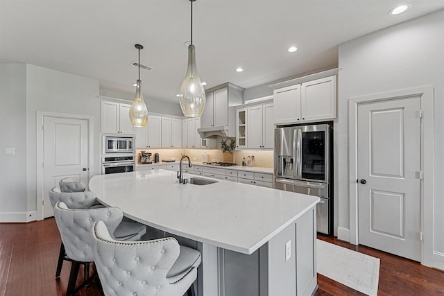 2603 Open Prairie Ln, Katy, TX 77493 - kitchen featuring stainless steel appliances, a sink, dark wood-style flooring, white cabinets, and recessed lighting