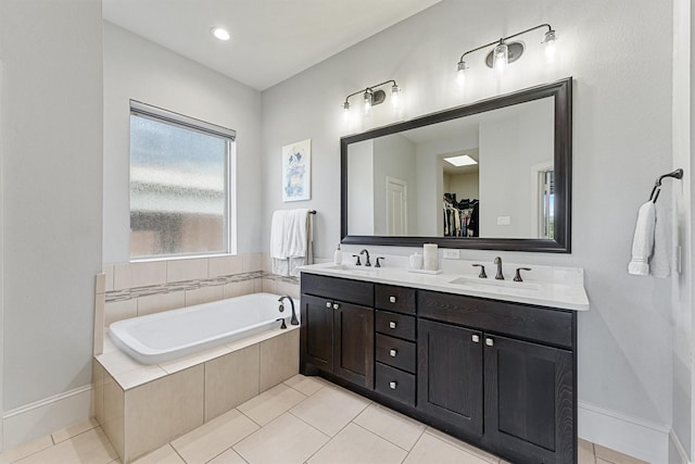 2603 Open Prairie Ln, Katy, TX 77493 - bathroom with double vanity, a bath, tile patterned floors, and a spacious closet