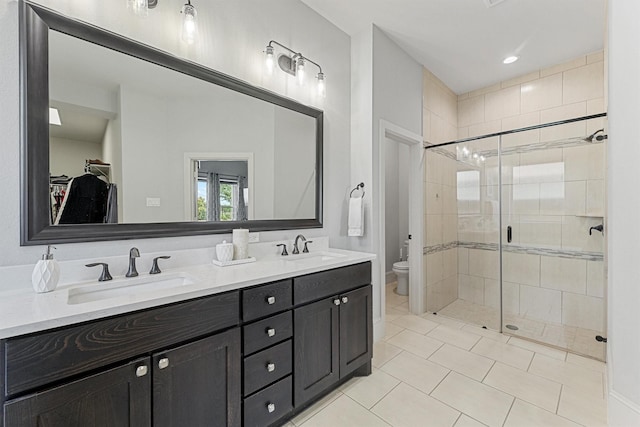 2603 Open Prairie Ln, Katy, TX 77493 - bathroom with double vanity, a shower stall, toilet, a spacious closet, and tile patterned flooring